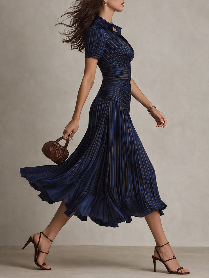 Navy blue ruched midi dress with V-neck, short sleeves, and layered flared hem