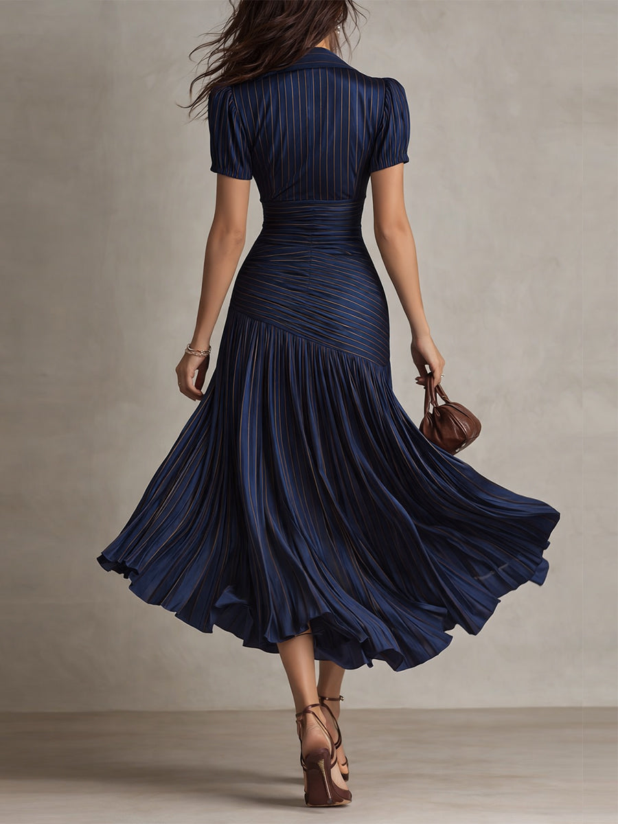 Navy blue ruched midi dress, back view, short sleeves and pleated flared skirt