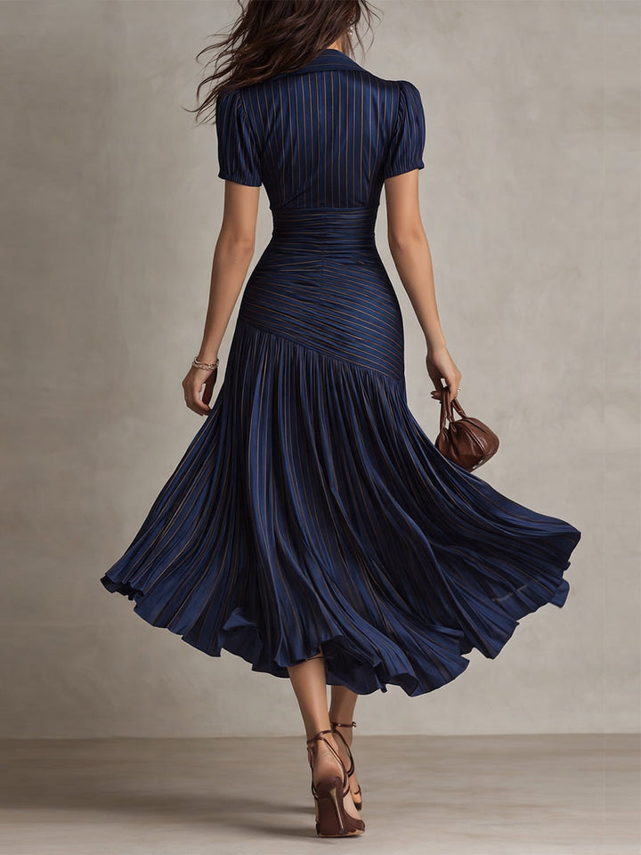 Navy blue ruched midi dress, back view, short sleeves and pleated flared skirt