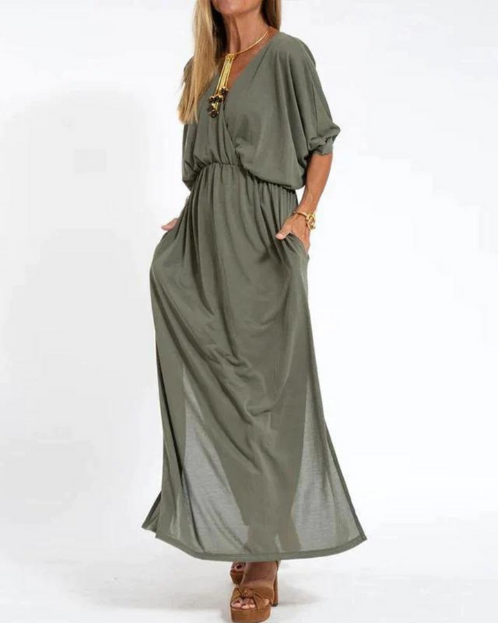 Green bohemian summer dress with V-neck, elastic waist, and flowy maxi skirt
