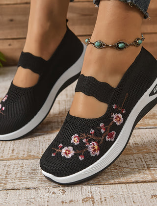 Black knit orthopedic comfort slip-on shoes with floral embroidery and cushioned sole