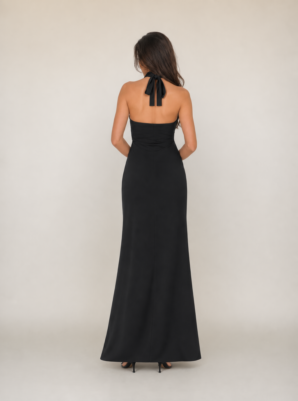 Black sleeveless halter-back maxi dress with tie detail and floor-length skirt
