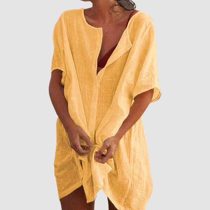 Yellow soft loose fit dress with V-neck, short sleeves, and front tie knot.