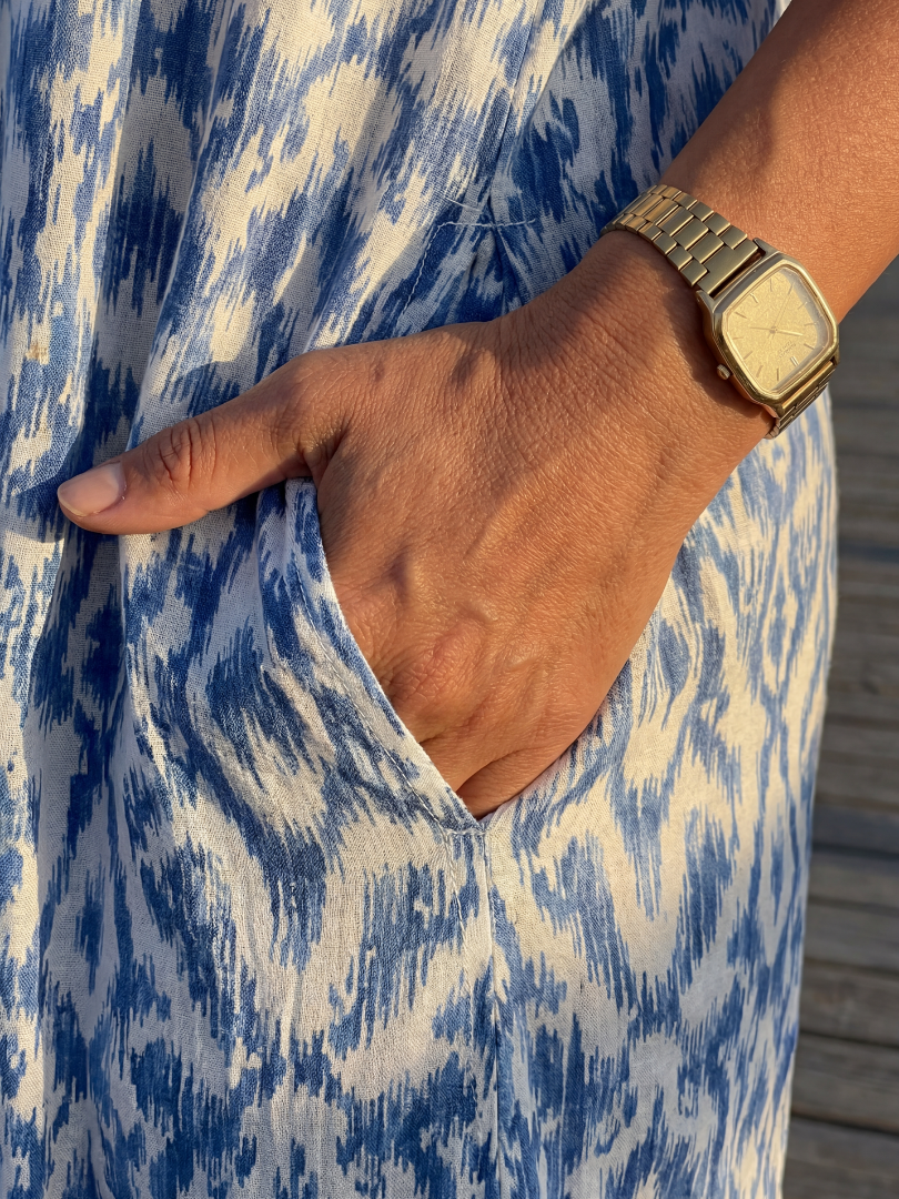 Blue and cream patterned dress fabric with V-neckline and short sleeve cuff