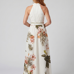 Back view: white halter maxi dress with open-back neckline and gathered waist; floral