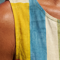 Sleeveless patchwork dress detail with yellow, blue, and red striped blocks