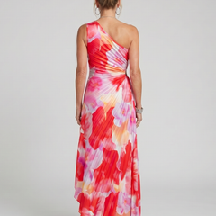 Back view one-shoulder pleated midi dress with flowing red, pink, and cream print
