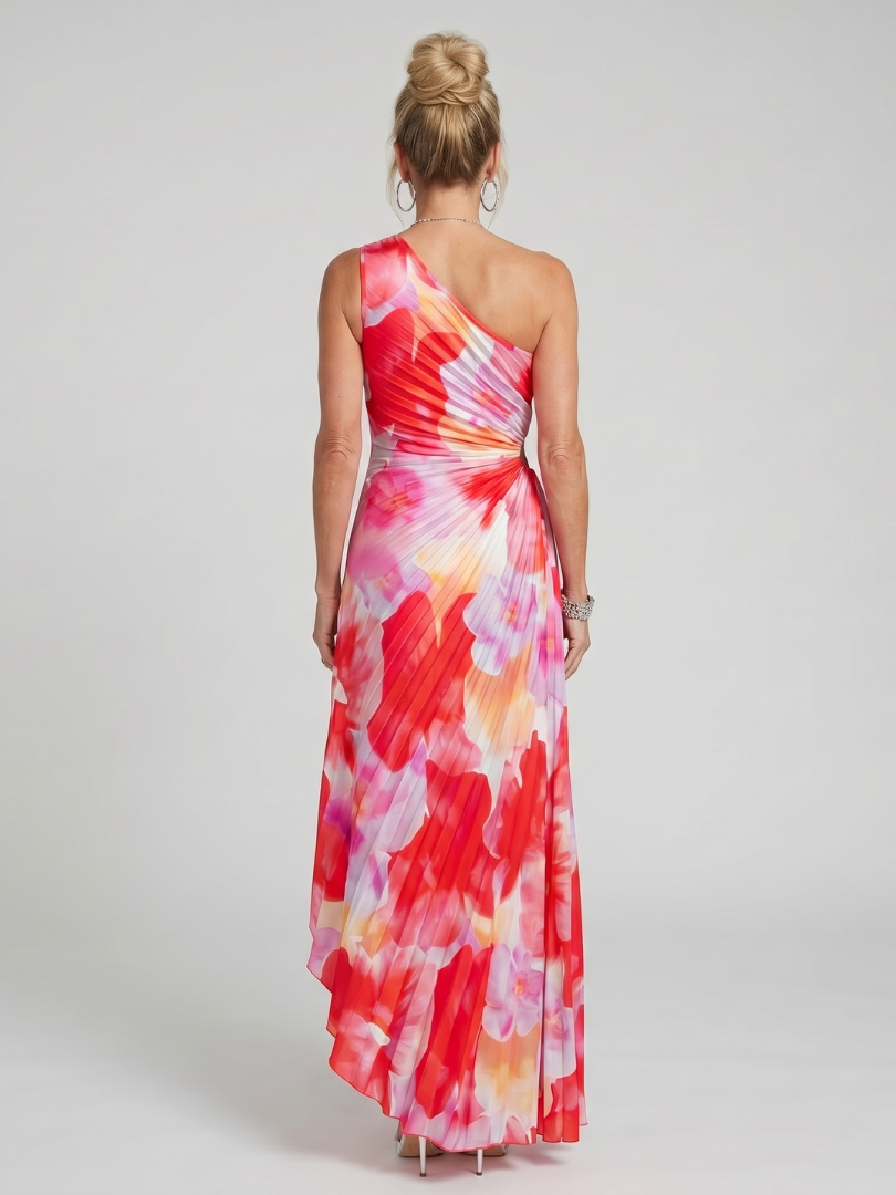 Back view one-shoulder pleated midi dress with flowing red, pink, and cream print