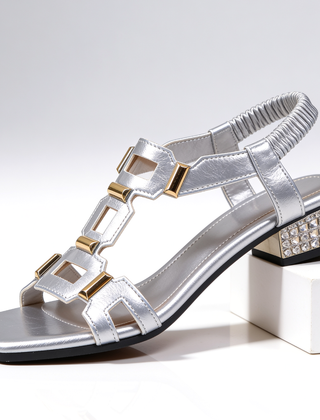 Silver metallic strappy heeled sandals with jeweled block heel and ankle strap