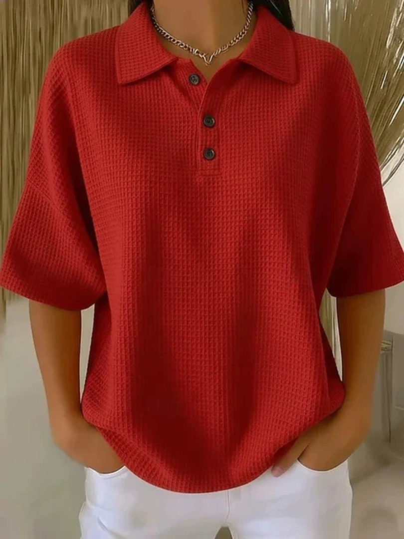 Red waffle knit polo blouse with short sleeves, pointed collar, three-button placket