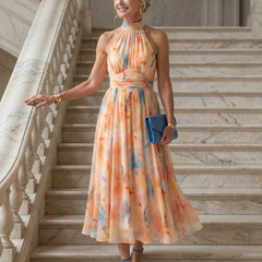 Halter midi dress in pastel orange-blue watercolor print, flowing mid-length skirt