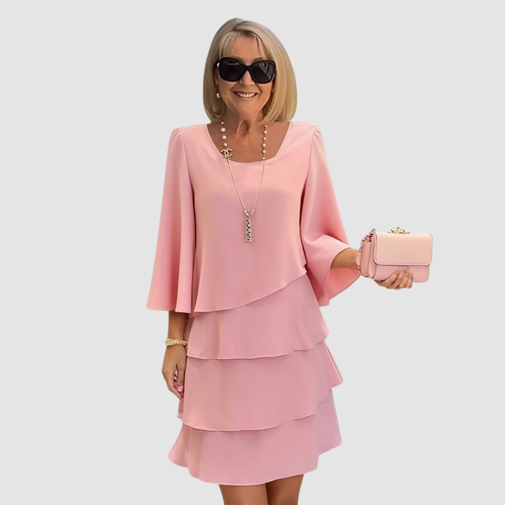 Pink layered short dress with long sleeves and scoop neckline, tiered skirt.