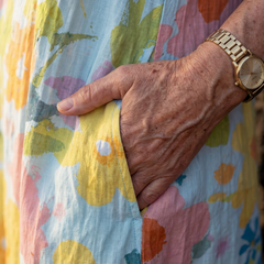 Close-up of multicolor floral sleeveless midi dress fabric and side seam