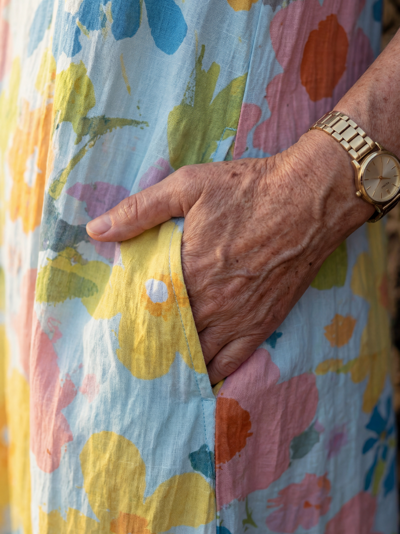 Close-up of multicolor floral sleeveless midi dress fabric and side seam