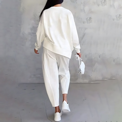 White two-piece lounge set with long-sleeve sweatshirt and tapered cuffed jogger pants
