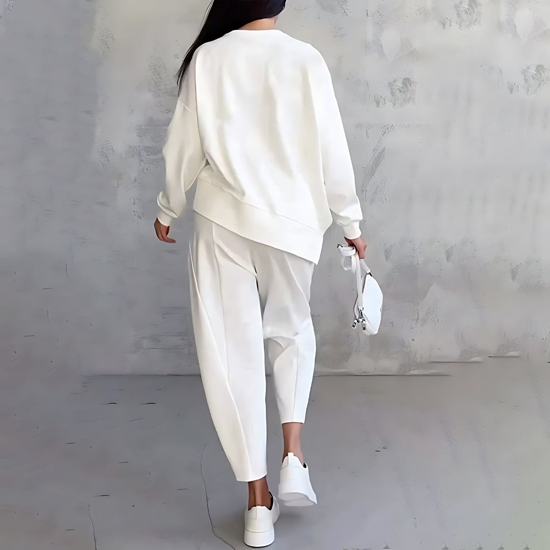 White two-piece lounge set with long-sleeve sweatshirt and tapered cuffed jogger pants