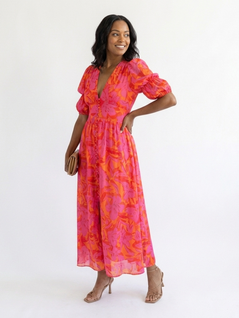 Pink floral V-neck midi dress with puff sleeves and flowing skirt, side view