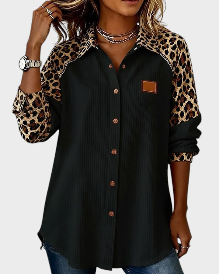 Black button-down shirt with leopard print sleeves and brown chest patch