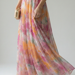 Soft wrap maxi dress hem and side drape in pink, orange, and greenish watercolor tones