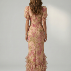 Floral pink high-neck maxi dress, back view, short puff sleeves and tiered ruffle hem.