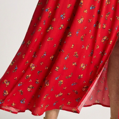 Red floral midi dress close-up of gathered skirt and side slit with pink underlayer