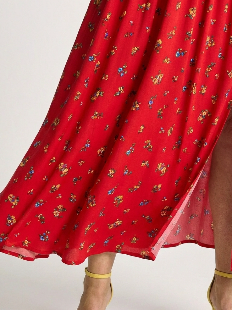 Red floral midi dress close-up of gathered skirt and side slit with pink underlayer