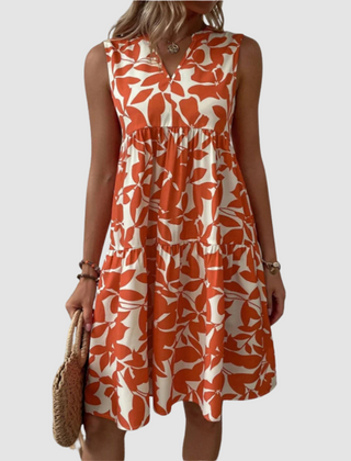 Red sleeveless V-neck flowy dress with leaf-pattern print and gathered skirt