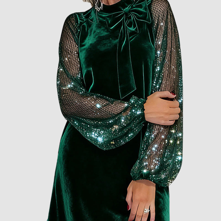 Green velvet dress with bow neckline, sequined mesh sleeves and sash detail