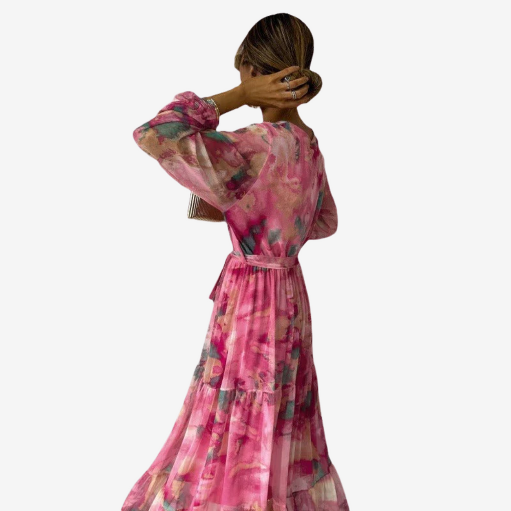 Pink floral maxi dress with tiered skirt, belted waist, and flowy bell sleeves