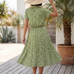 Green printed belted midi dress from back view with short sleeves