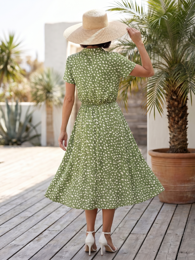Green printed belted midi dress from back view with short sleeves
