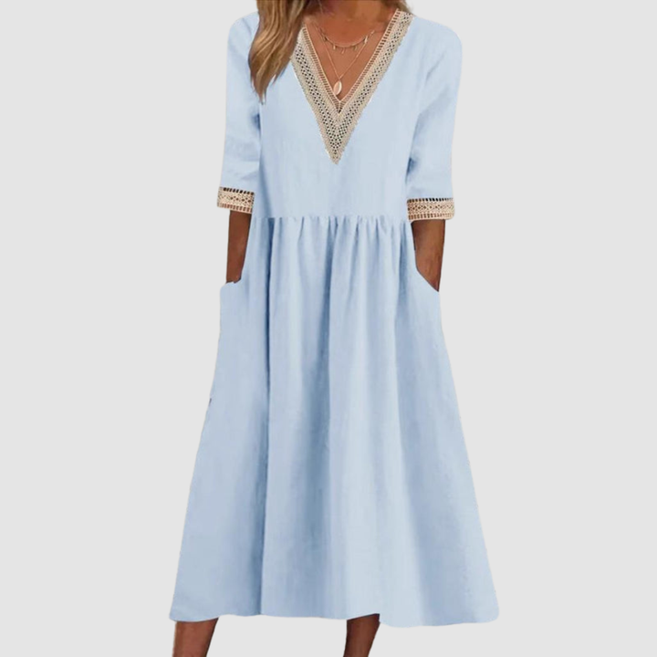 Light blue mid-length dress with V-neck embroidered trim, 3/4 sleeves, and tiered skirt