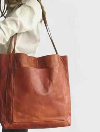 Rust leather tote bag with double handles and front zippered pocket