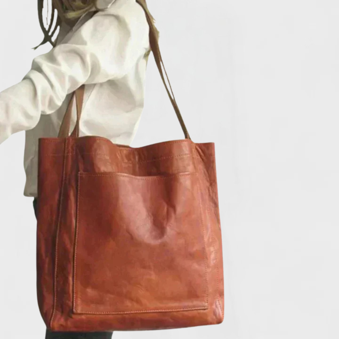 Rust leather tote bag with double handles and front zippered pocket