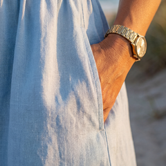 Light blue midi dress close-up: gathered fabric and hem, three-quarter sleeve