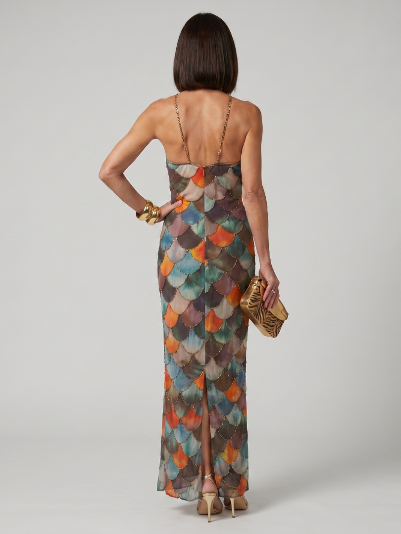 Back view of multicolor scale-pattern fitted maxi dress with halter straps
