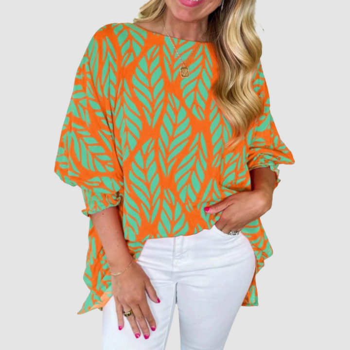 Orange loose blouse with green leaf pattern, wide sleeves, and rounded neckline