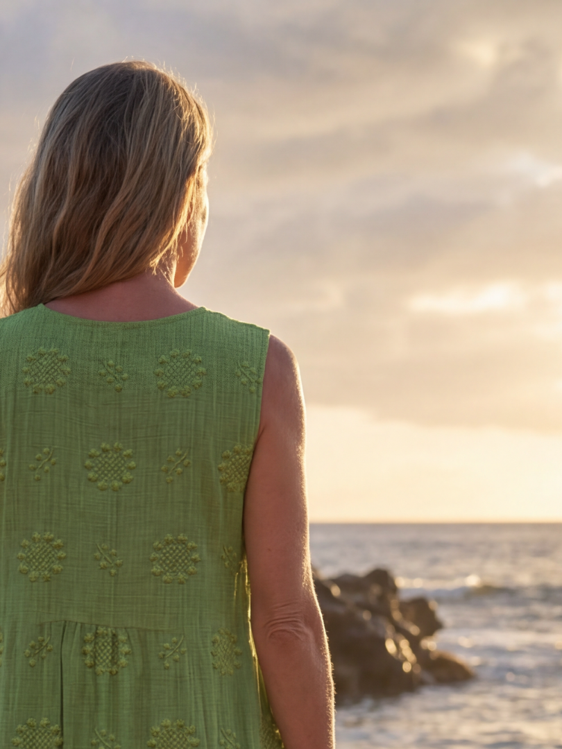 Green sleeveless midi dress, back view with floral embroidery pattern on shoulders