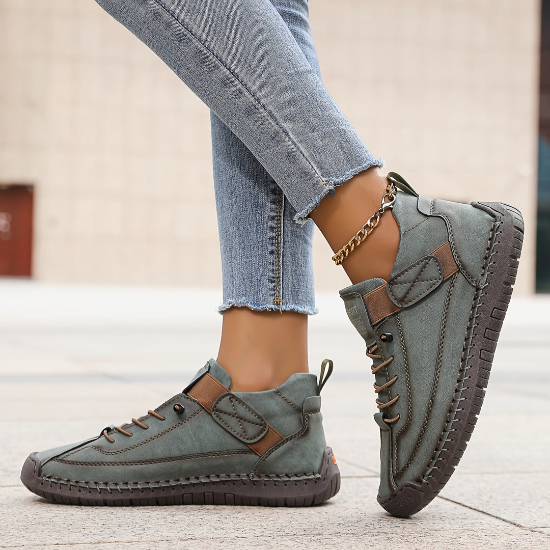 Orthopedic comfort sneaker in teal-green with lace-up and padded toe strap.