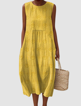 Mustard sleeveless midi dress with embroidered eyelet clover pattern, tiered skirt