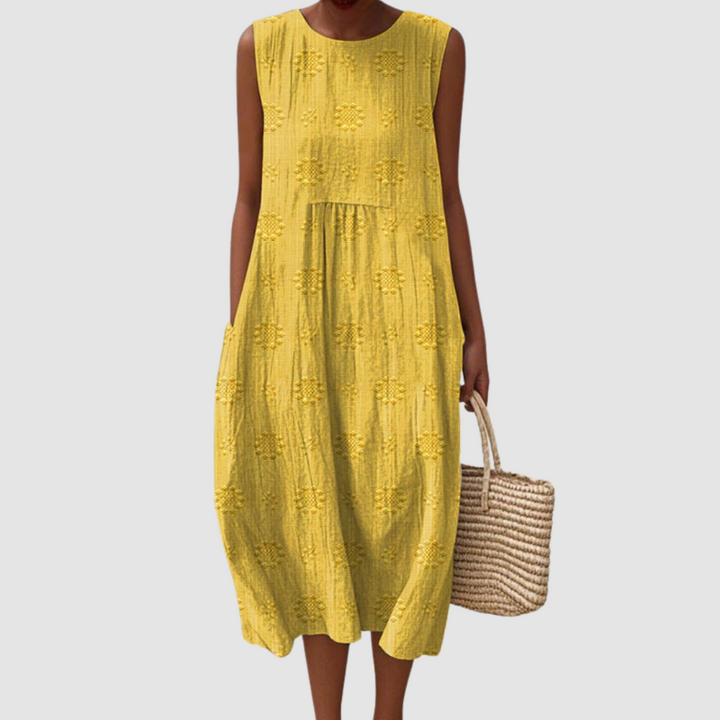 Mustard sleeveless midi dress with embroidered eyelet clover pattern, tiered skirt