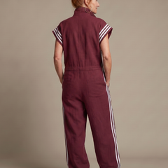 Back view burgundy zip-front jumpsuit with white striped side panels
