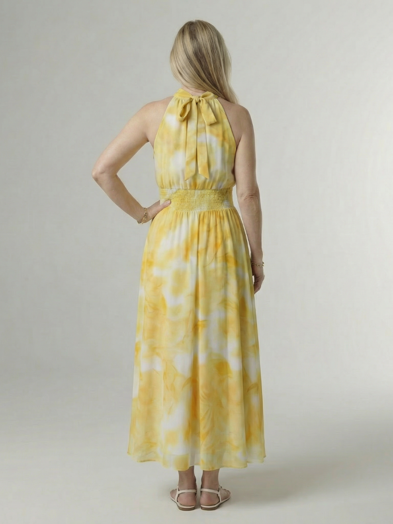 Yellow tie-dye halter midi dress, back view with gathered neckline and smocked waist