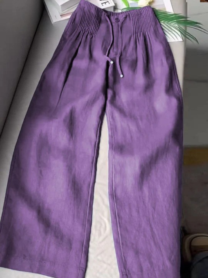 Purple wide-leg trousers with elastic waistband, drawstring, and front button