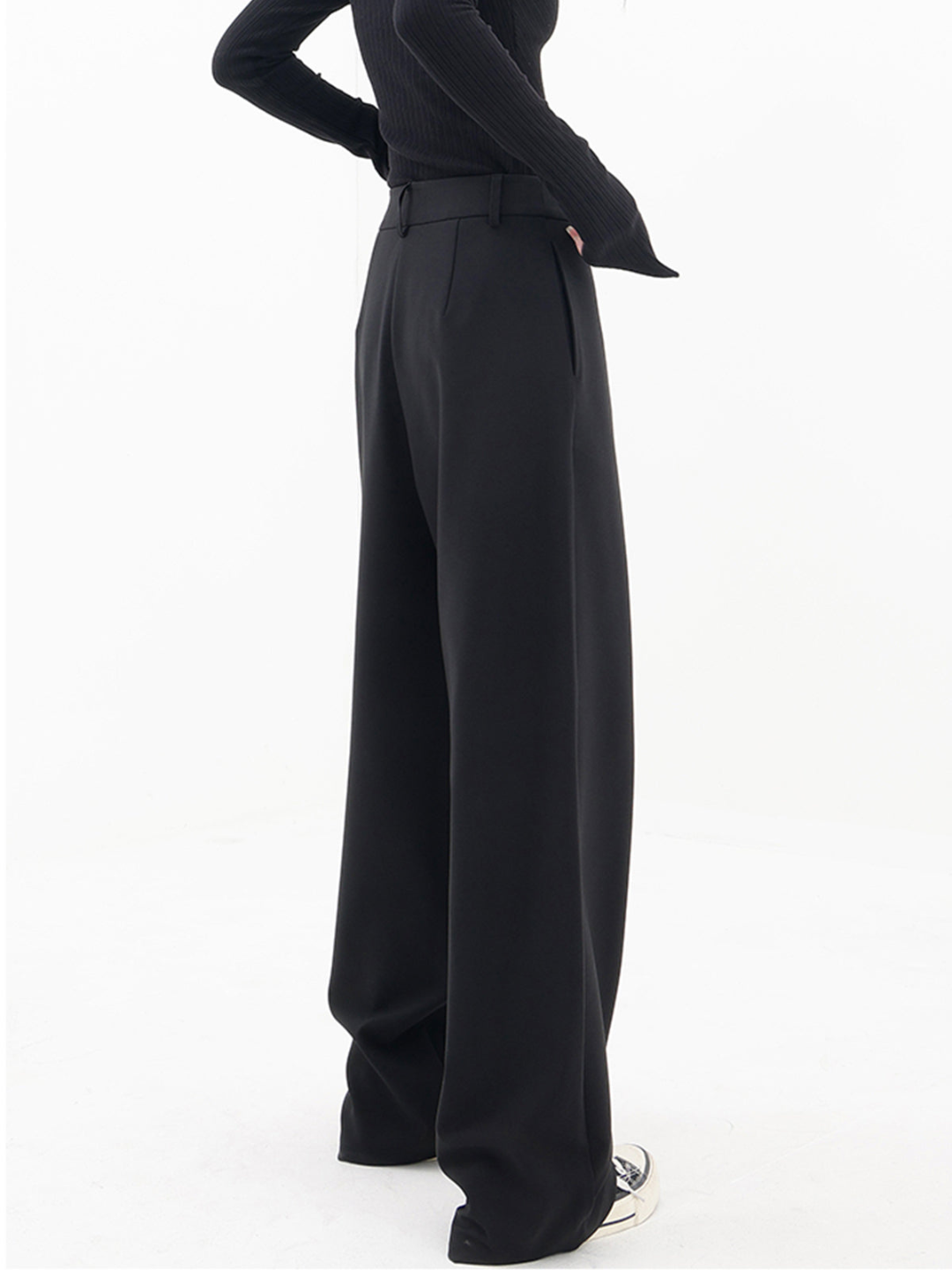 Black baggy trousers with high waist and wide draped legs, side diagonal panel