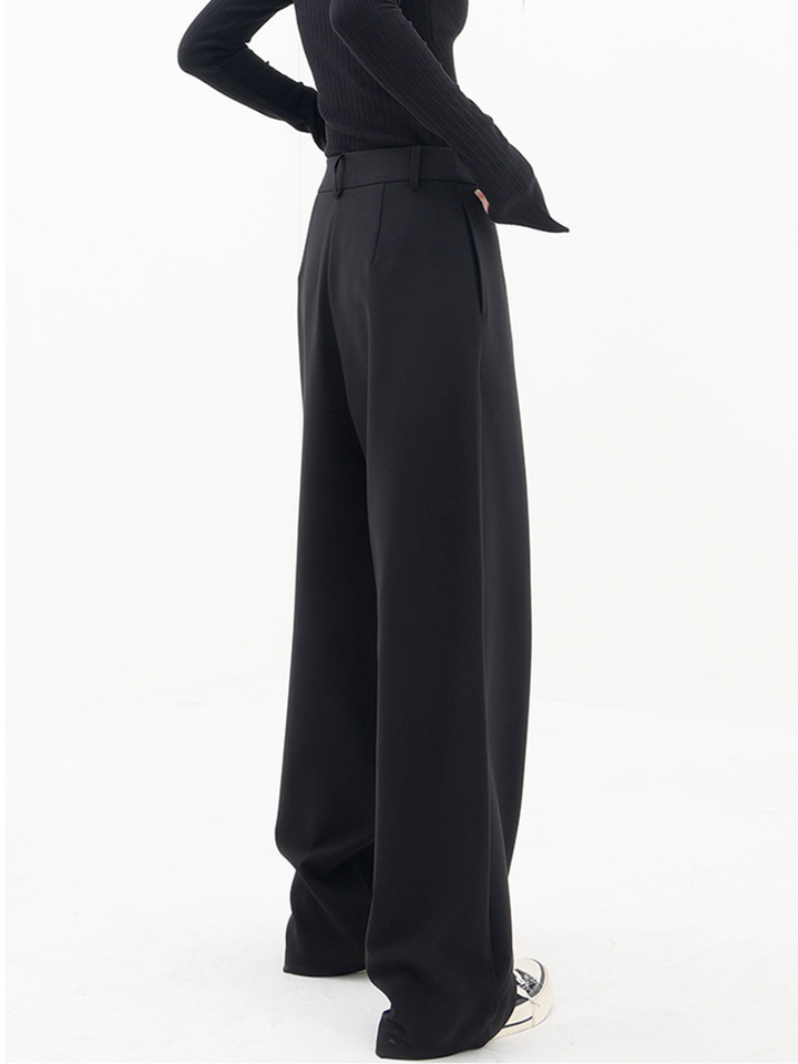Black baggy trousers with high waist and wide draped legs, side diagonal panel