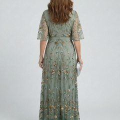 Sage green floral maxi dress with halter back, short sleeves and tiered skirt
