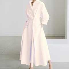 Light pink shirt dress with collar, long sleeves, and fitted waist tie