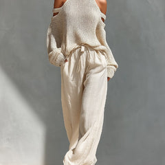 Beige cold-shoulder knit turtleneck top with matching drawstring trousers
