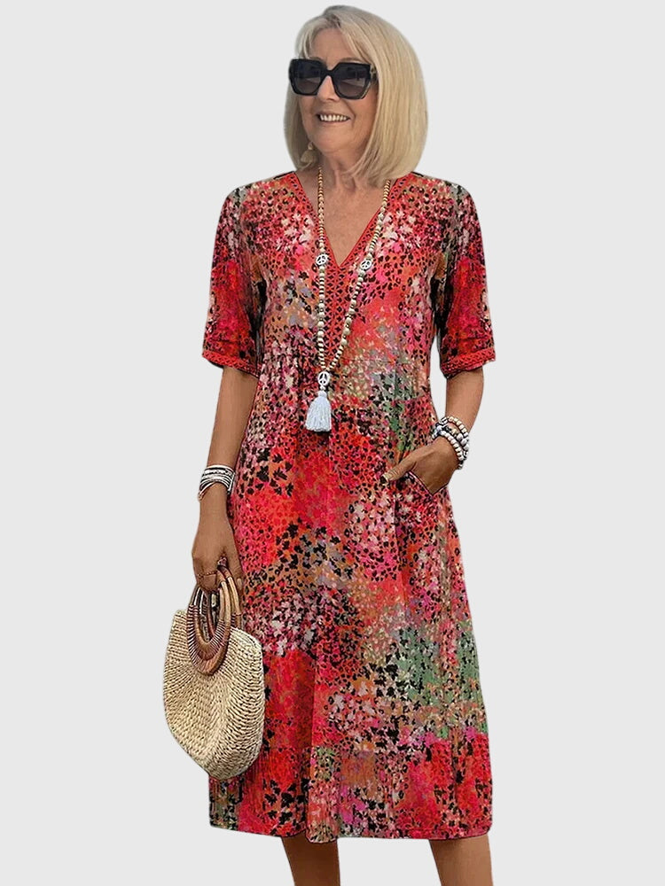 Scarlet red floral midi dress with V-neck, short sleeves, and white tassel detail